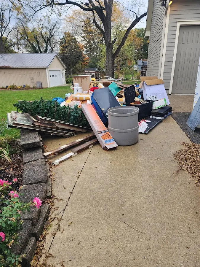 Dumpster being loaded with debris for Estate Cleanout Dumpster Rental in Kearney
